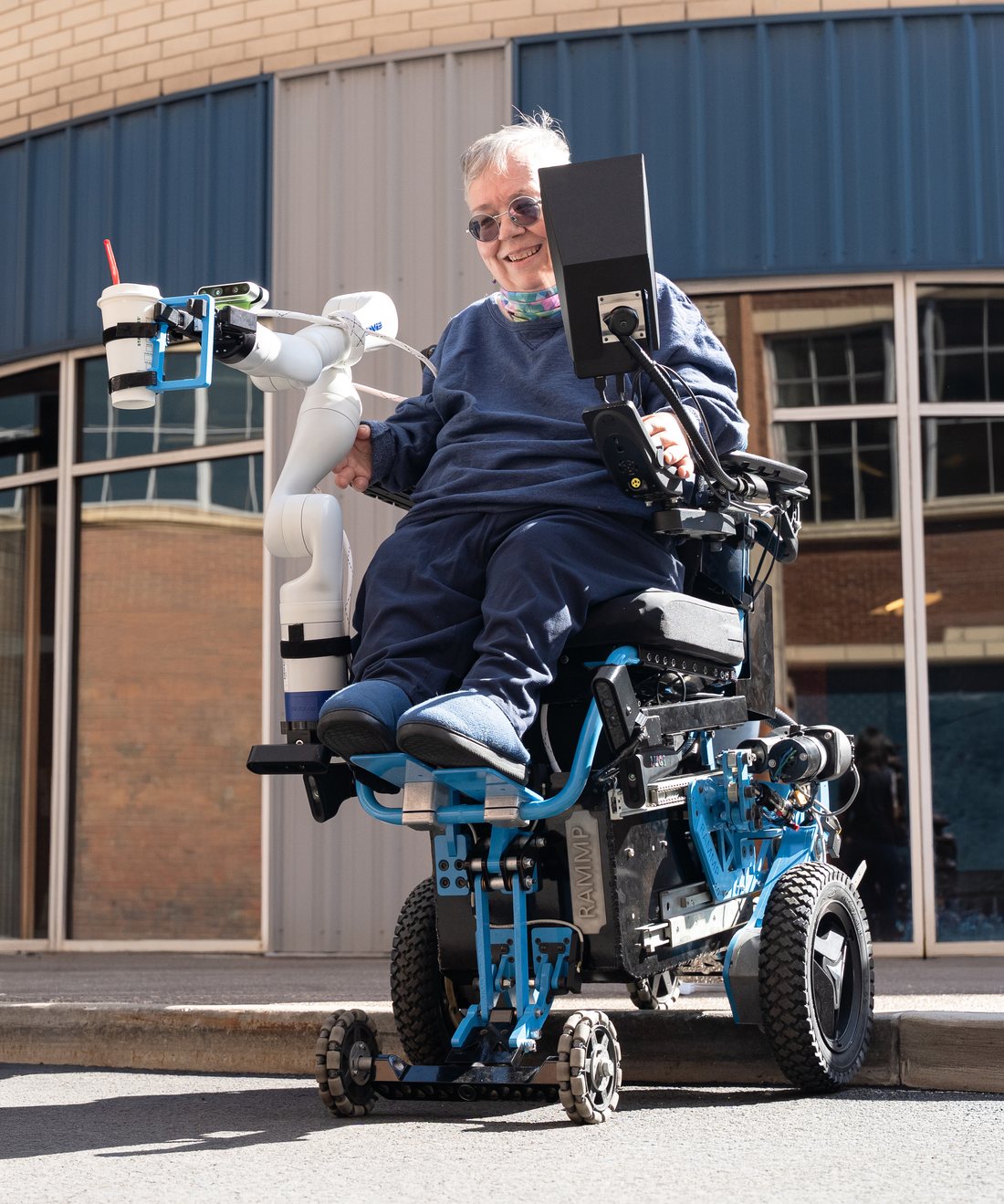 Person using the ATDev RAMMP automated wheelchair system